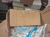 a person holding a box with a bunch of items inside of it