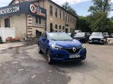 the blue car is parked in front of a building with a sign on it