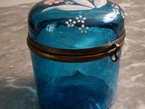 a blue glass box sitting on a counter top