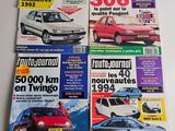 four magazines of different cars on display on a white surface