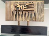 a bronze sculpture of a bird on top of a wooden block