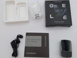 a box of gadgets and a cell phone on a table