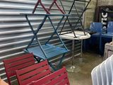 many different colored chairs and tables in a room