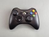 a close up of a controller on a table with a white background