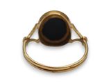 an image of a gold ring with a black stone in the middle