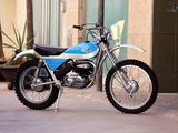 a blue and white dirt bike parked on the side of the street