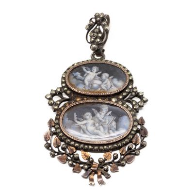 a close up of a pendant with two pictures on it