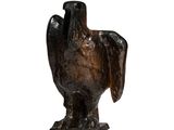 sculpture of a bird on a stand on a white surface