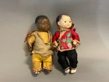 two dolls that are standing next to each other