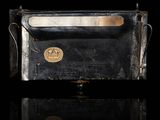 an image of a black purse with a gold coin on it