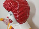 a statue of a clown with a baseball bat in his hand