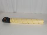 a yellow and black pipe sitting on top of a white table