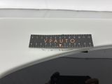 a person taking a picture of a sticker on the back of a car