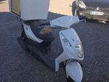 a scooter with a tv on top of it in a parking lot