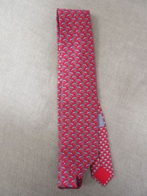 an image of a red neck tie with a blue and white design