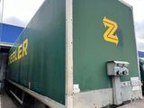 a green box truck parked in a parking lot