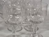 several empty wine glasses are lined up on a table