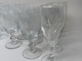 several empty wine glasses are lined up on a white surface