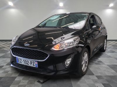 the black car is parked on a checkered floor in the garage