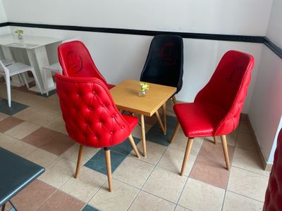 three chairs and a table in a small room