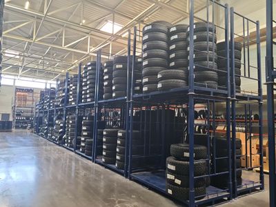 a lot of tires stacked on a rack in a warehouse