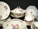 a lot of plates and bowls that are sitting on a table