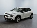 the white citrole is parked in a large room