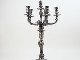 an antique silver candelabra with five candles on a stand