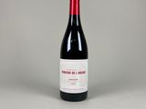 the bottle of red wine is sitting on the table