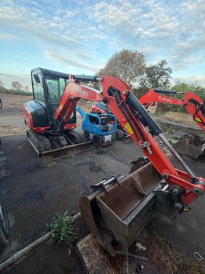two small machines that are sitting in the dirt