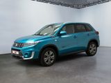 the blue suv is parked in a large room with white walls