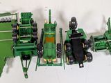four toy tractors that are sitting next to each other