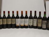 several bottles of wine are lined up in a row on a table