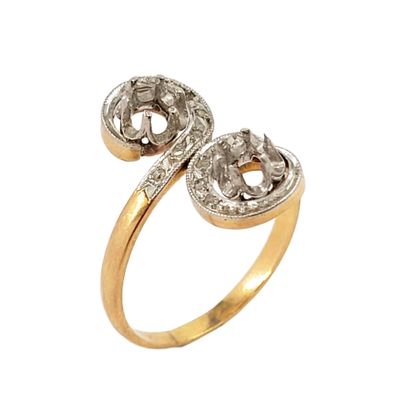 a close up of a gold and diamond ring on a white background