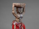 an image of a statue of a woman carrying a basket on her head