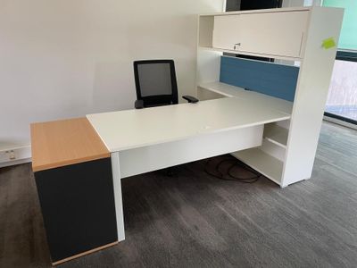 a desk with a laptop and a monitor on it