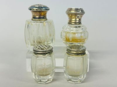two salt and pepper shakers sitting on a clear plate