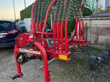 an image of a red machine parked in front of a house