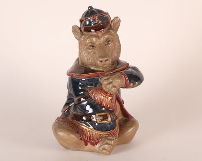 a ceramic bear figurine sitting on a white surface