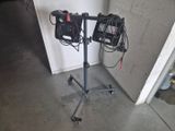 two speakers that are on a tripod in a garage