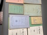 a lot of old books on a table together