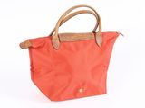 an image of a red bag with a brown handle on a white background