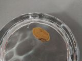 a small cookie in a glass bowl on a table