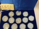 an image of a blue box containing nine silver coins