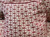 a pile of pillows sitting on top of each other on the floor