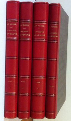 four red books are stacked on top of each other on a shelf