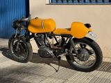 a yellow motorcycle parked in front of a building