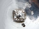 a close up of a metal object with a hole in it