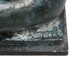 a close up of a bronze statue of a dog
