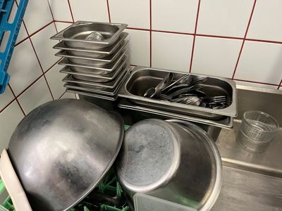 many pots and pans on the counter in the kitchen